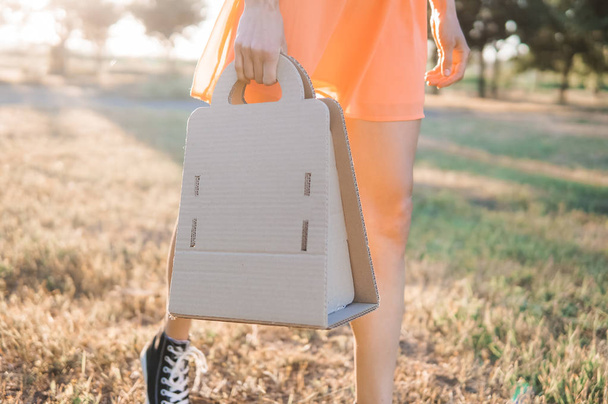 Woman with paper eco bag outdoors on a sunny summer day - Fotografie, Obrázek