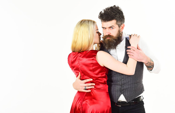 Woman in red dress and man in vest. Bearded hipster and attractive lady at dancing contest, copy space. Couple in love, passionate dancers in elegant clothes, white background. Dancing couple concept - Valokuva, kuva