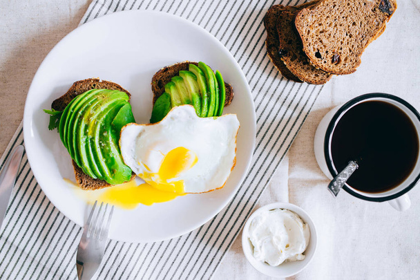 Healthy avocado toast, coffee, and eggs on white background. Top view.  - Фото, изображение