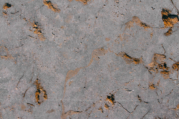 The texture of a natural gray stone with golden impregnations. Copy space stone background. - Foto, afbeelding