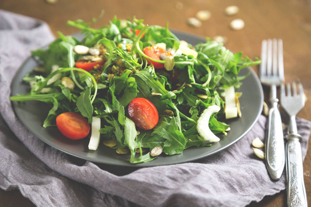 Green salad, arugula, cherry tomatoes, celery - Фото, изображение