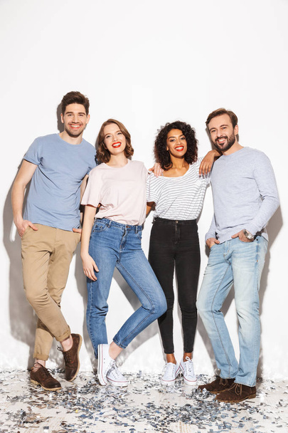 Full length of a group of cheerful multiracial people standing together and laughing isolated over white background - Foto, Bild