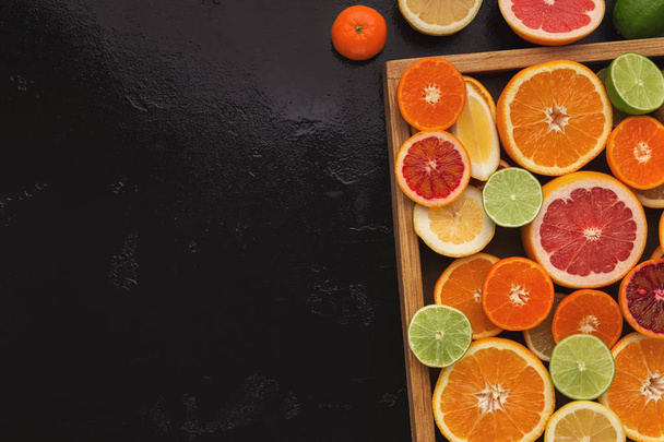 Variety of ripe citruses on black background - Foto, Imagem