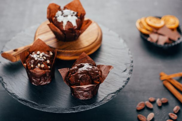 Sweet chocolate muffins on dark slate board - Fotó, kép
