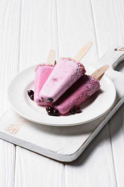 Fruit ice pops in plate on wooden background - 写真・画像