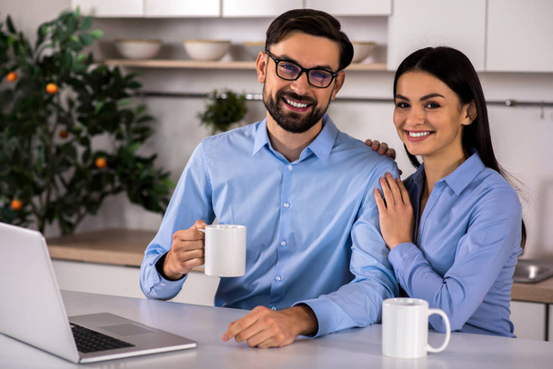 Feel my support. Positive couple sitting in the kitchen and drinking tea - Foto, Bild
