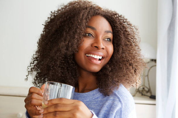 Close up portrait of beautiful young african american woman drinking cup of tea - Photo, Image