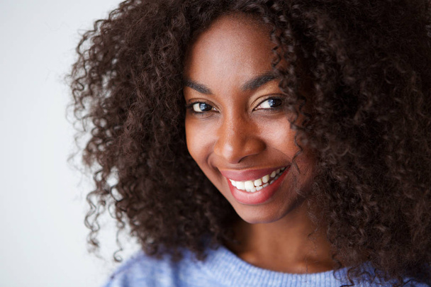 Közelről portréja mosolygó fiatal afrikai-amerikai nő, fehér háttér - Fotó, kép