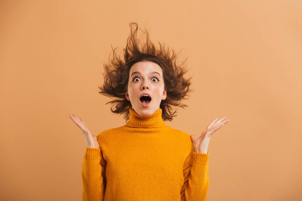 Picture of excited shocked young woman standing isolated looking camera. - Φωτογραφία, εικόνα