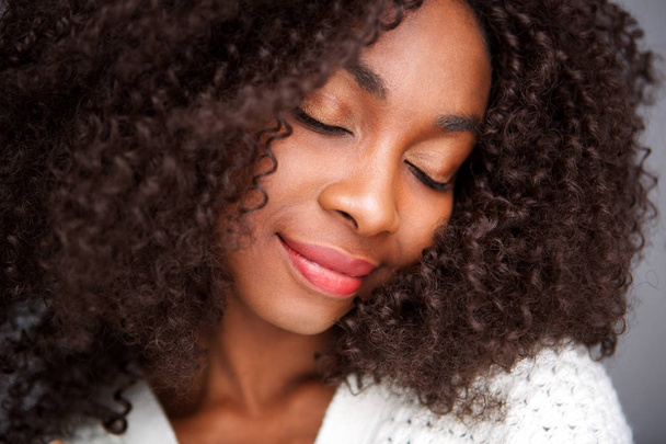Close up portrait of young african woman relaxing with eyes closed - Photo, Image