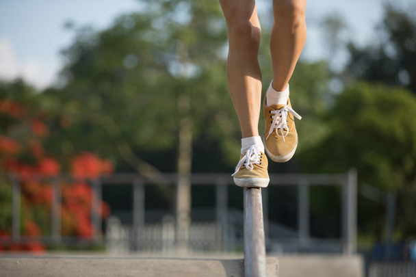 Legs walking on steel pipe with balance - Foto, Bild