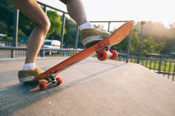Cropped image of skateboarder skateboarding on skatepark ramp - Photo, image