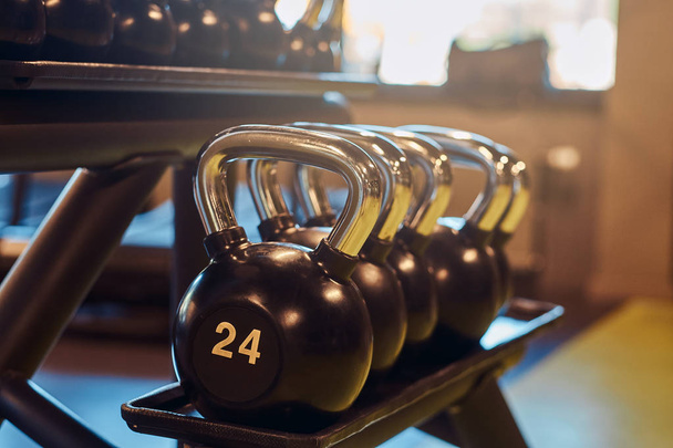 Closeup image of dumbells on a stand. Gym equipment - Photo, Image