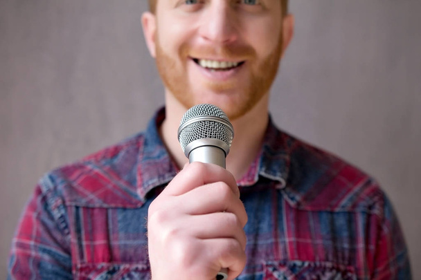 Handsome guy with microphone. - 写真・画像