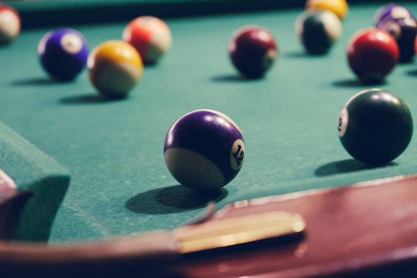 Billiard pockets and balls on a green table - Foto, Imagen