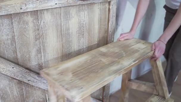 Close up: girl moves a wooden stylish stepladder - Filmati, video