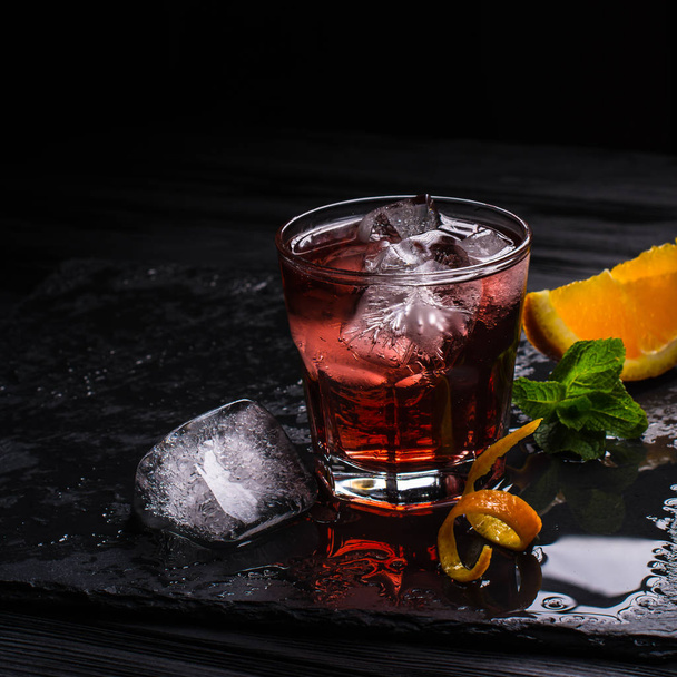 Mezcal Negroni cocktail. Smoky Italian aperitivo. Orange peel. - 写真・画像