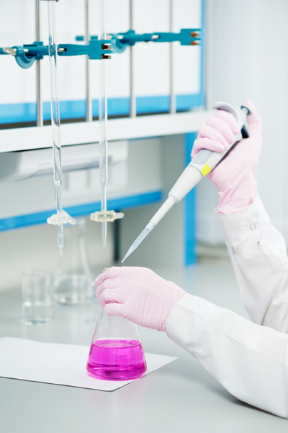 Doctor hands with flask dropper in a laboratory - Zdjęcie, obraz