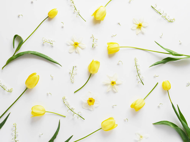 Floral composition with narcissus flowers, lily-of-the-valley and yellow tulips on white background - Photo, Image
