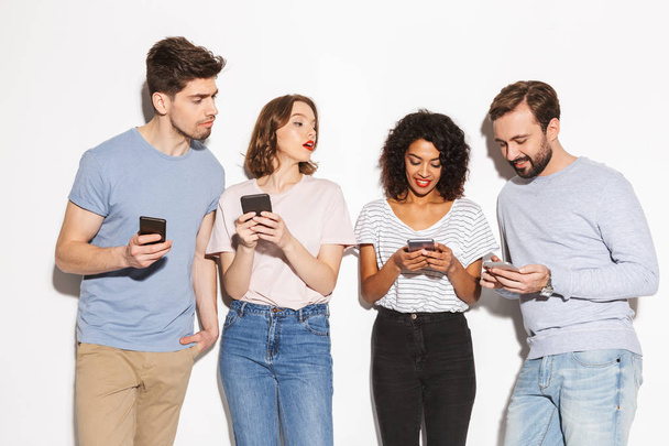 Group of modern multiracial people using mobile phones isolated over white background - Foto, Bild
