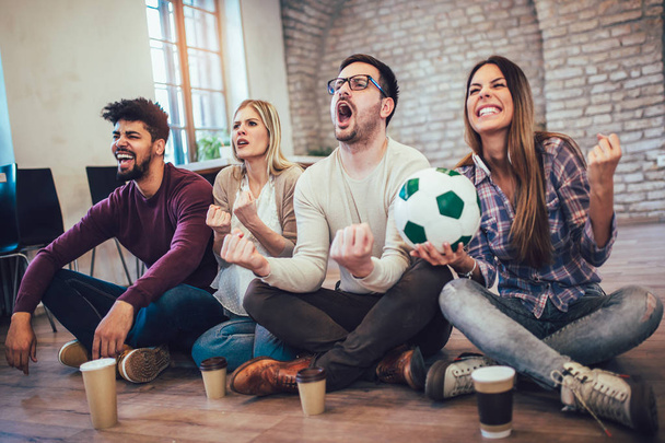 Szczęśliwy przyjaciół lub piłka nożna fanów oglądania piłki nożnej w telewizji i świętuje zwycięstwo. Pojęcie przyjaźni, Sport i rozrywka. - Zdjęcie, obraz