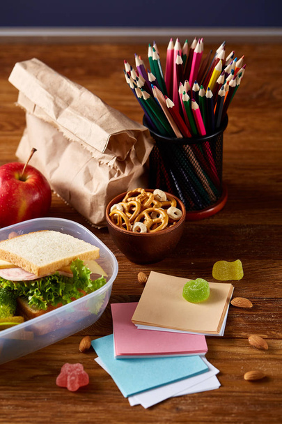 Preparing ham sandwiches for scool lunchbox on wooden background, close up. - Photo, image