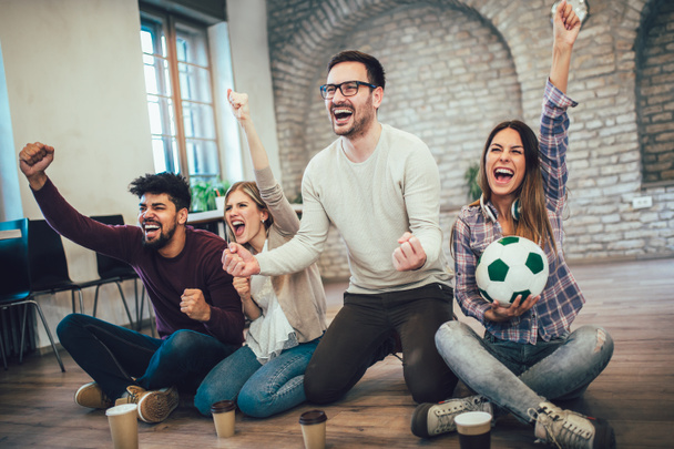 Happy friends or football fans watching soccer on tv and celebrating victory. Friendship, sports and entertainment concept. - Foto, Imagem