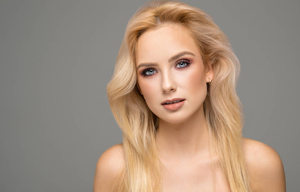 Portrait of blond female model with natural skin and blue eyes - Zdjęcie, obraz