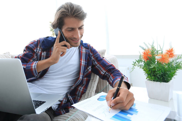 young man working with financial documents at home. - Photo, Image