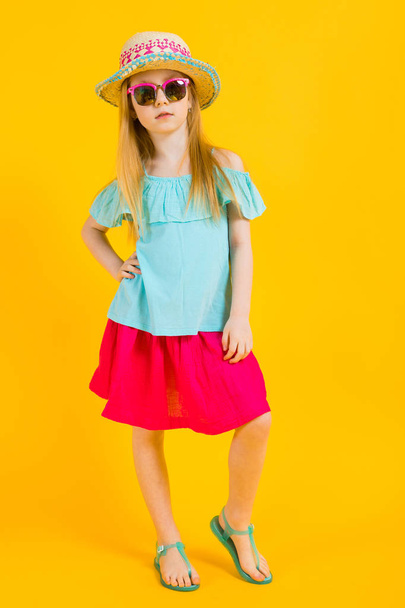 Girl with red hair on a yellow background. Charming girl in bright summer clothes. - Foto, afbeelding