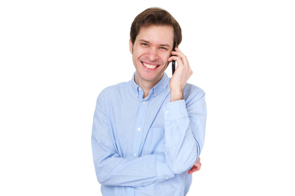 Fechar-se de homem de negócios feliz de pé e falando ao telefone contra fundo branco
 - Foto, Imagem
