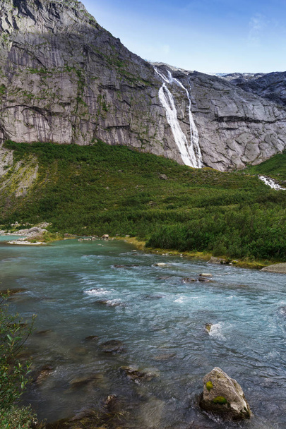 blue glacial water of Briksdal River in Norway - Fotó, kép