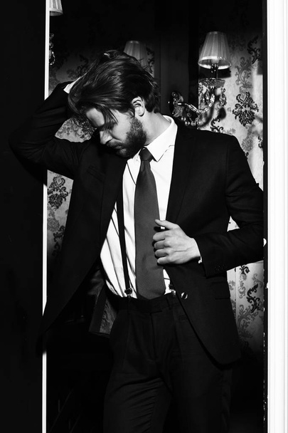 bearded man, businessman in suit and red tie against wallpaper - 写真・画像