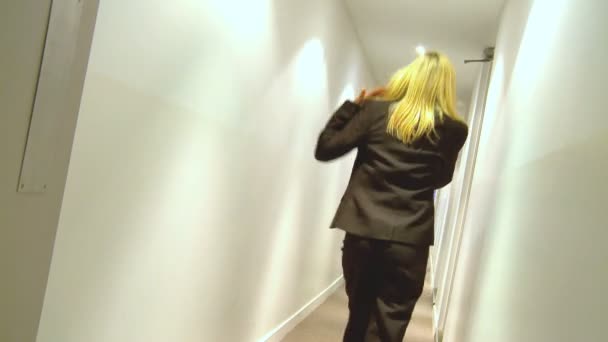 Young businesswoman using a mobile phone on way to team meeting - Footage, Video