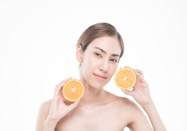 young woman holding juicy oranges before her face . Healthy eating concept. Diet. Isolated over white. - Фото, изображение