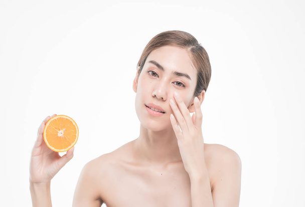  young woman holding juicy oranges before her face . Healthy eating concept. Diet. Isolated over white. - Foto, immagini