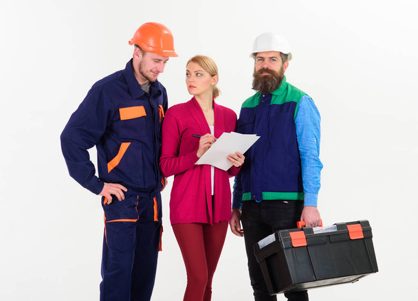 Men in hard hats and uniform and woman in suit - Foto, Imagem