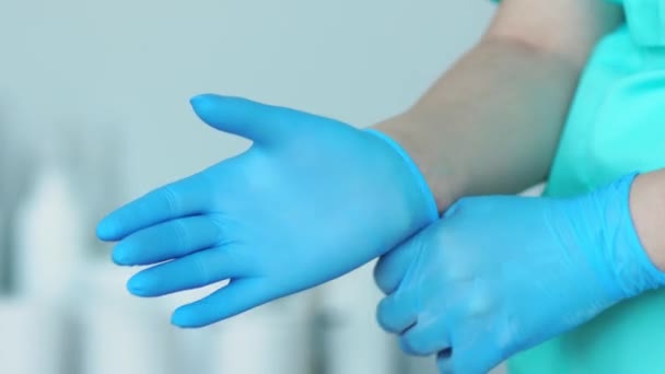 Close-up of the doctor wearing rubber gloves - Footage, Video