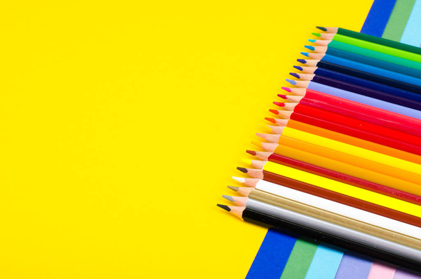 Set of colored pencils for schoolboy on bright background - Photo, Image