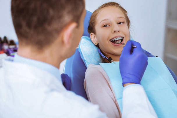 Pleased girl treating her teeth - Foto, Imagen