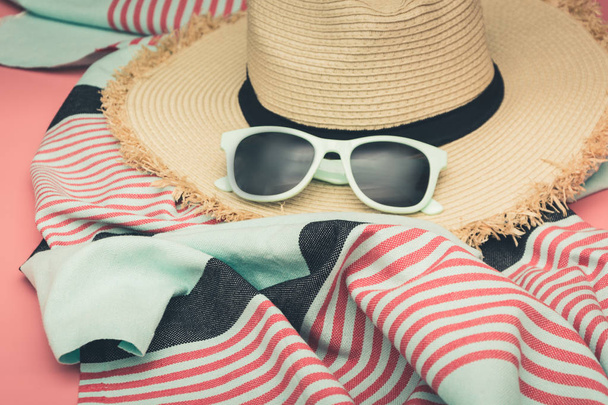 Straw beach sun-hat and sun glasses on punchy pink with space for text. Close up. - Fotoğraf, Görsel