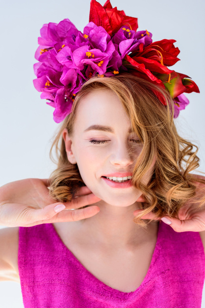beautiful happy woman with flowers in hair smiling with closed eyes isolated on grey - Foto, imagen