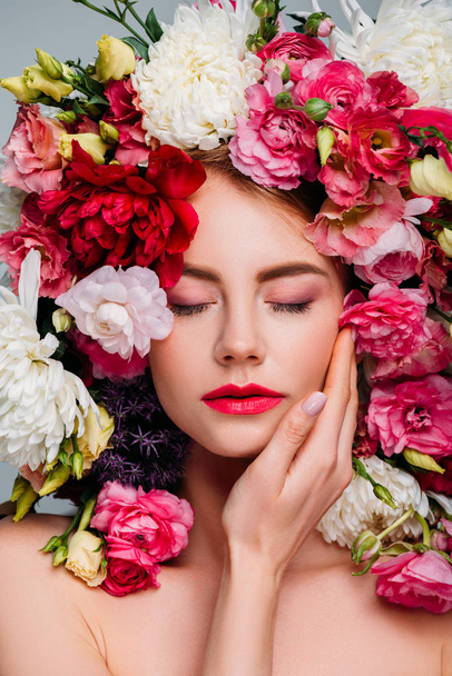beautiful young woman with closed eyes posing in floral wreath isolated on grey  - Photo, Image