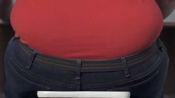 Fat teenager clumsily rising from chair, obesity problem in childhood, bullying - Πλάνα, βίντεο