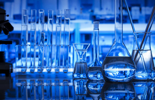 Science laboratory concept background. Microscope and laboratory glassware composition. - Photo, Image