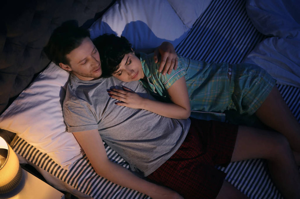 Young lovely couple sleeping in bed at home - Foto, Imagem