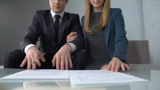 Wealthy couple signing housing purchase contract, real estate agency clients - Πλάνα, βίντεο