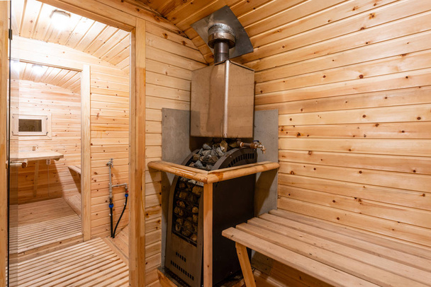 interior of sauna. rural mobile wooden bath in the form of a barrel in a pine forest - Photo, Image