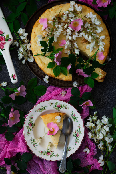 SOFT CAKE WITH WHITE CHOCOLATE RICOTTA AND ACACIA FLOWERS.vintage style.selective focus - Φωτογραφία, εικόνα