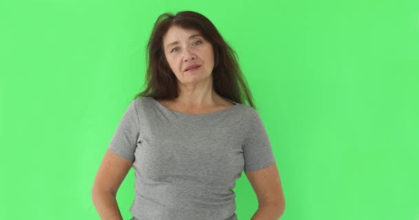 Serious wise woman looking at camera on chromakey - Footage, Video